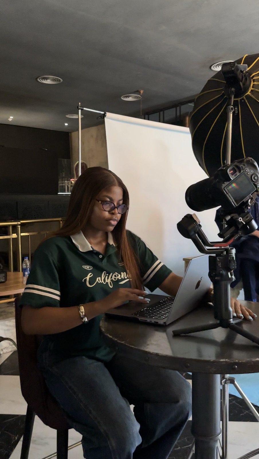 Geraldine shooting with a camera on a gimbal at a table setup